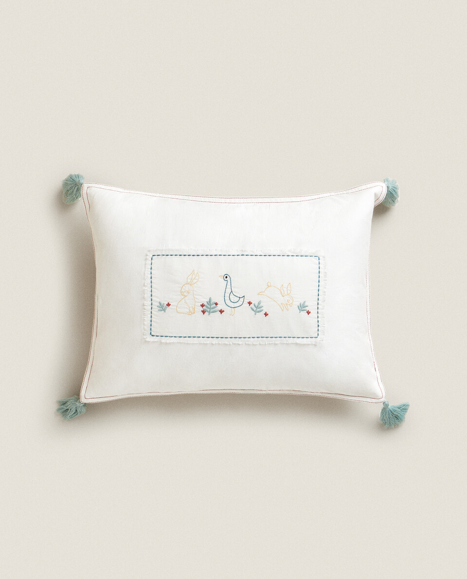 EMBROIDERED CUSHION WITH TASSELS