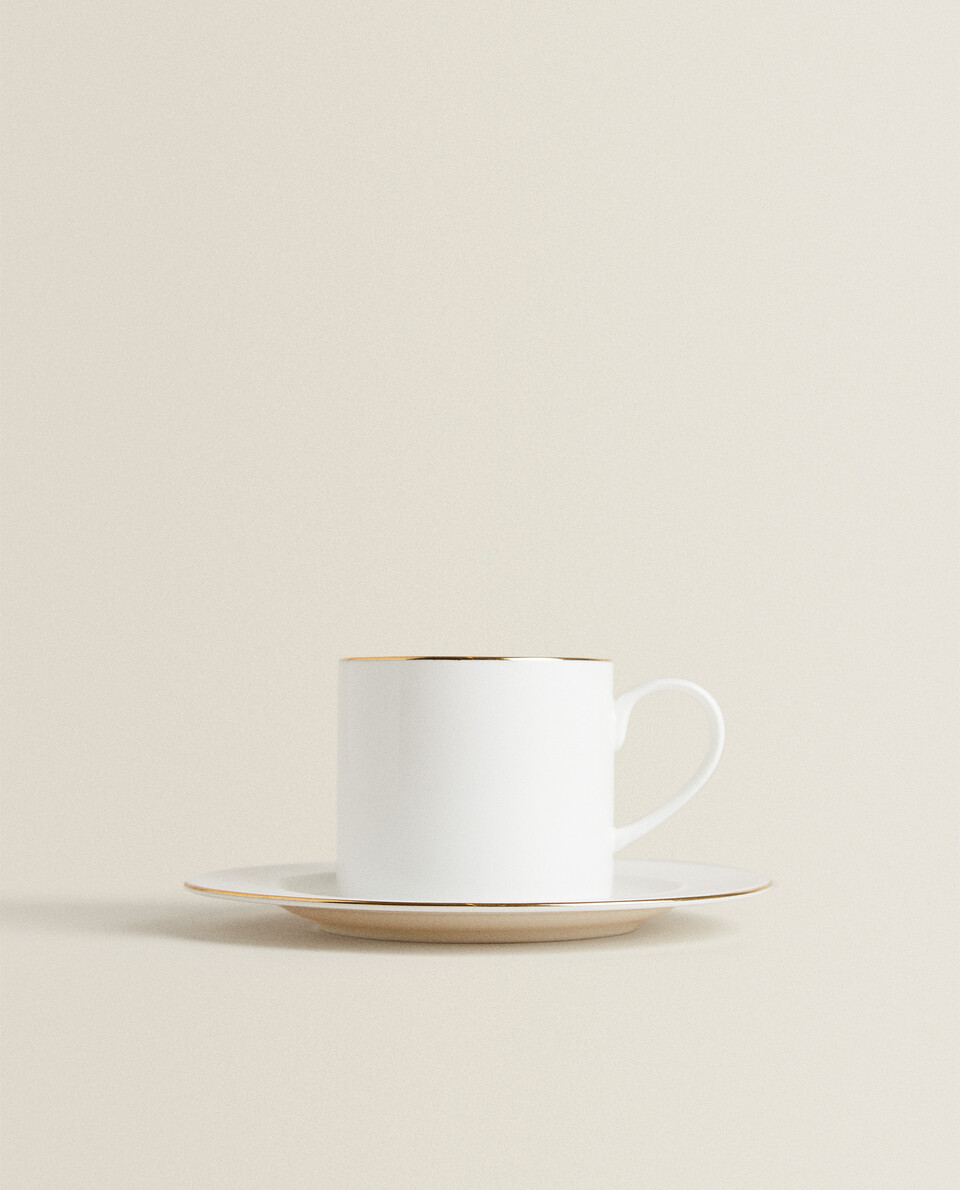 GOLD-RIMMED BONE CHINA TEACUP AND SAUCER