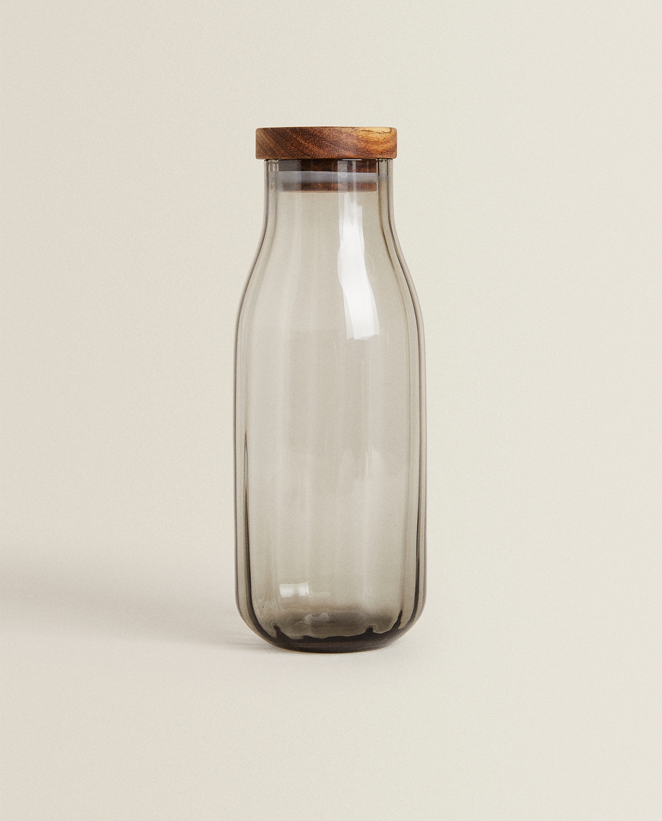 GLASS BOTTLE WITH RAISED DESIGN AND WOODEN LID