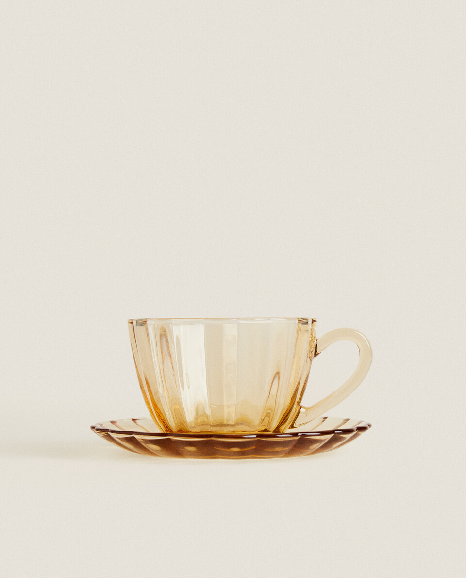 TEACUP AND SAUCER WITH RAISED DESIGN